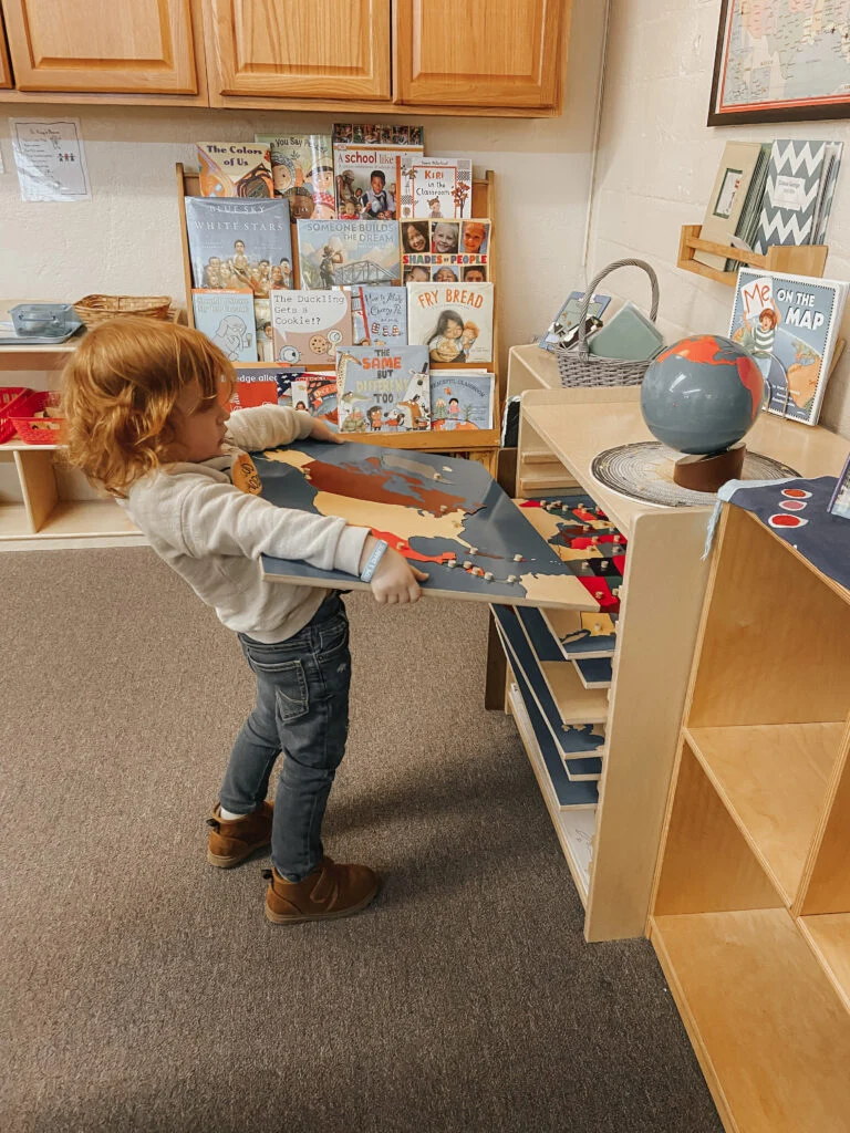 Child exploring classroom learning materials