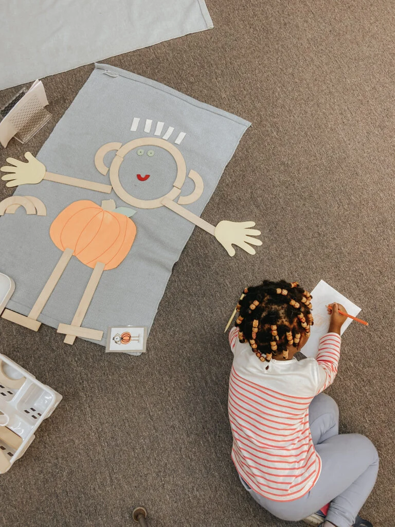 Preschool students working with Montessori materials